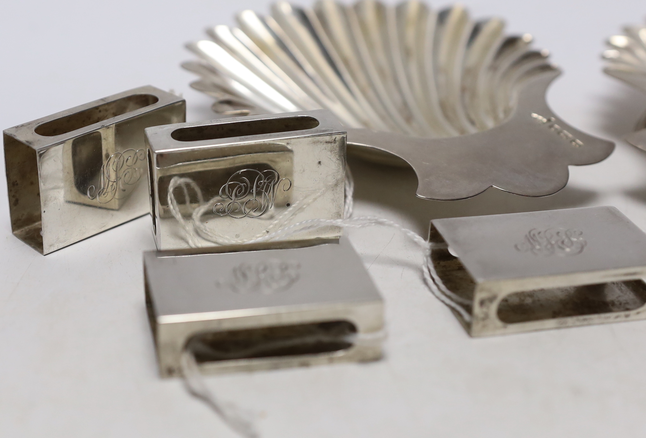 A pair of late Victorian silver butter shells, Walker & Hall, Sheffield, 1898, 12.6cm, together with a set of eight George VI silver matchbox sleeves, Birmingham, 1937.